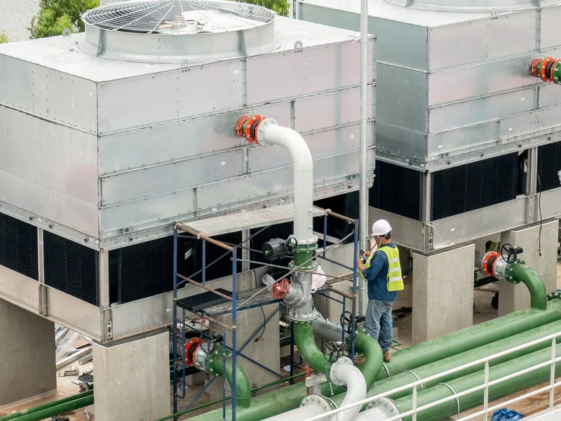 Man working on a huge rooftop chiller system