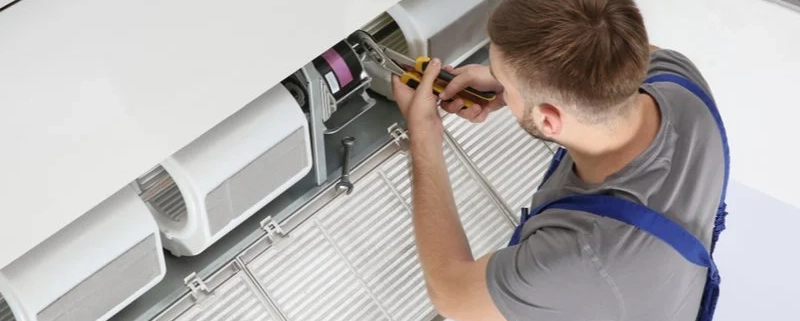 Technician working on an air conditioning system