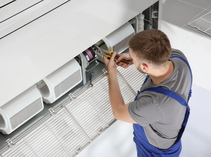 Technician working on an air conditioning system